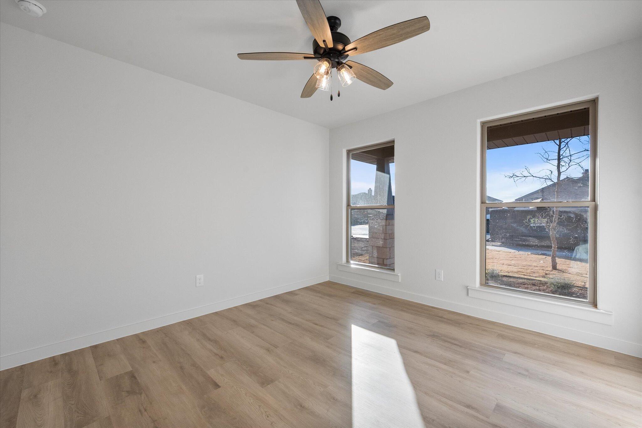 5309 Remington Avenue Lubbock, TX 79407 - Photo 17 of 22 an empty room with fan and windows