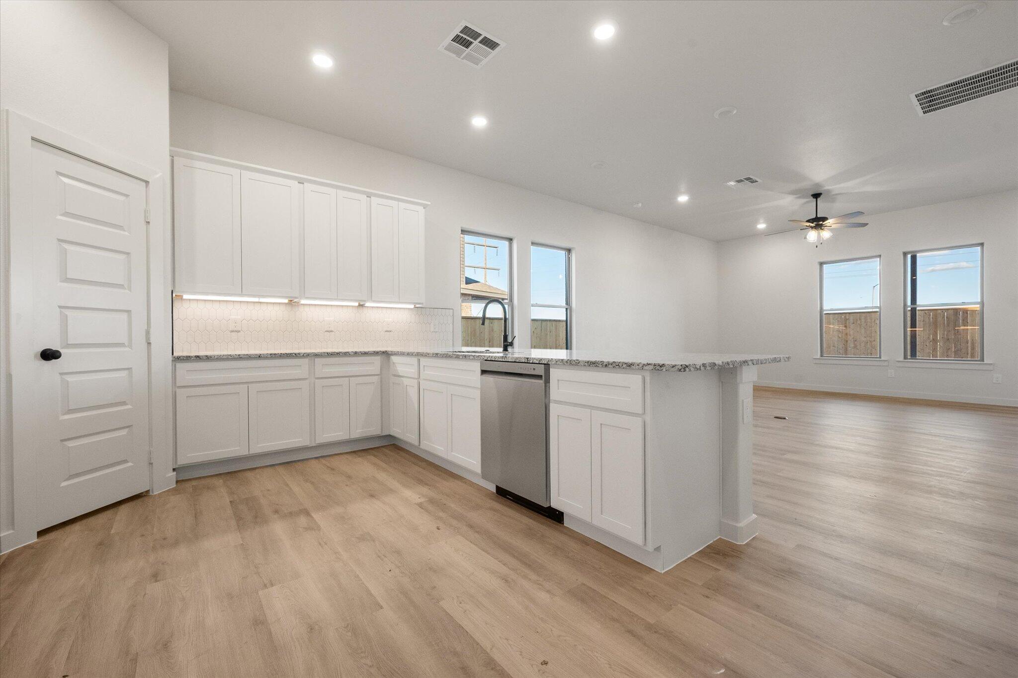 5309 Remington Avenue Lubbock, TX 79407 - Photo 3 of 22 a kitchen with white cabinets and white appliances