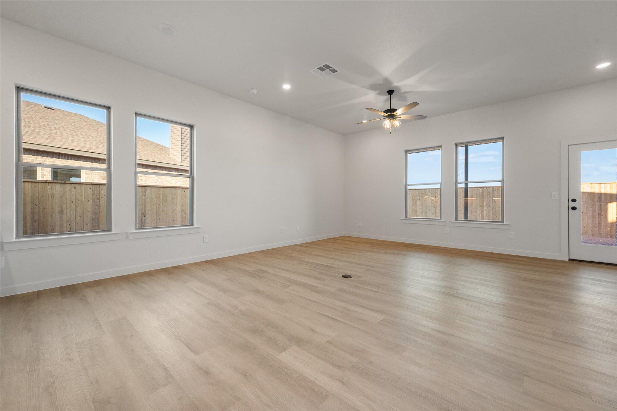 5309 Remington Avenue Lubbock, TX 79407 - Photo 7 of 22 wooden floor in an empty room with a window