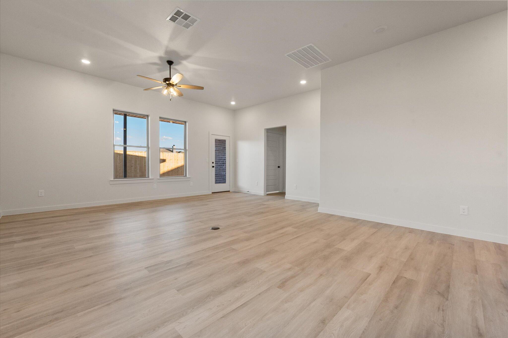 5309 Remington Avenue Lubbock, TX 79407 - Photo 8 of 22 wooden floor in an empty room with a window