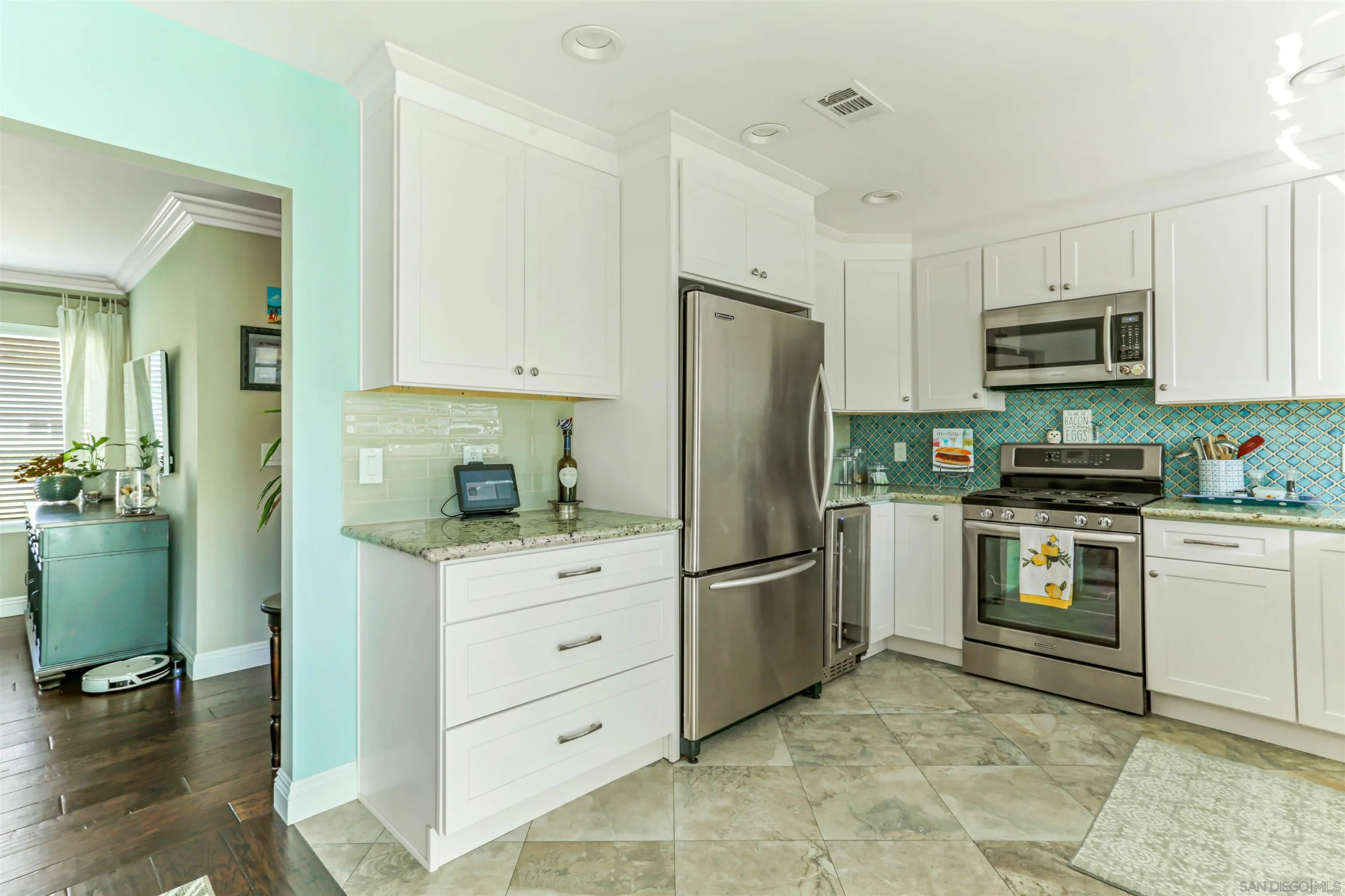 13515 Utopia Road Poway, CA 92064 - Photo 12 of 36 a kitchen with white cabinets and stainless steel appliances
