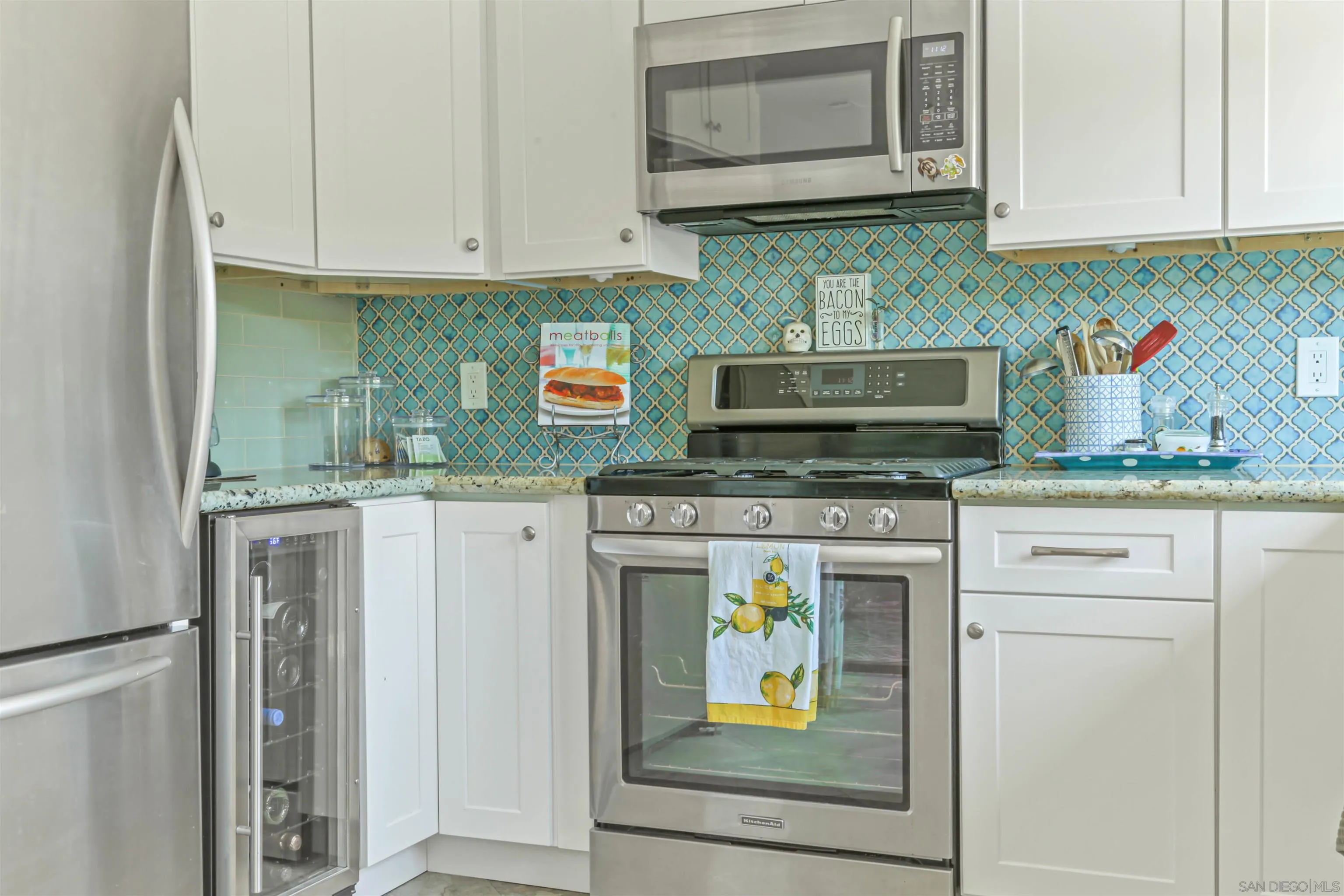 13515 Utopia Road Poway, CA 92064 - Photo 14 of 36 a kitchen with stainless steel appliances granite countertop a stove a microwave and refrigerator