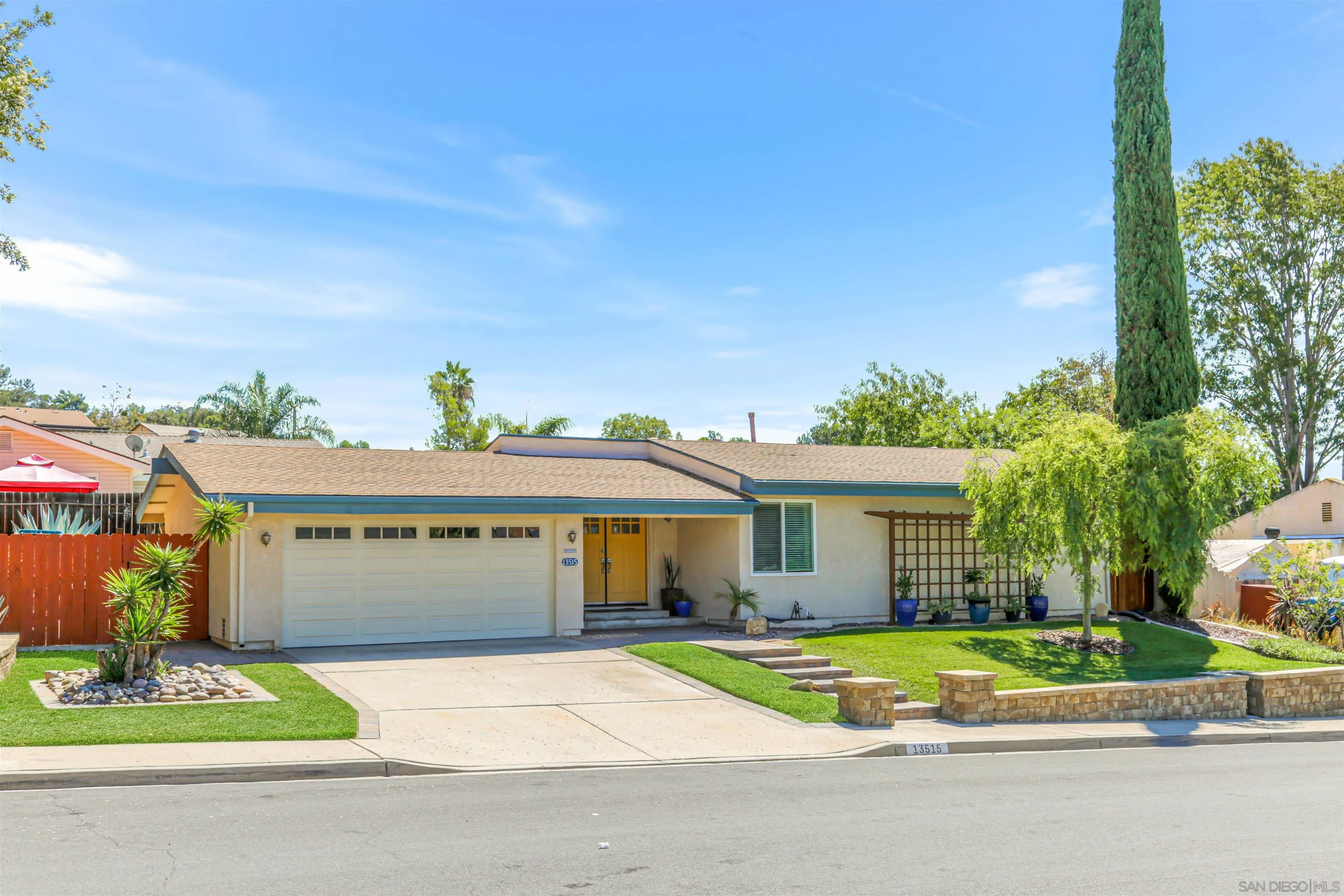 13515 Utopia Road Poway, CA 92064 - Photo 2 of 36 a view of a white house with a yard and plants