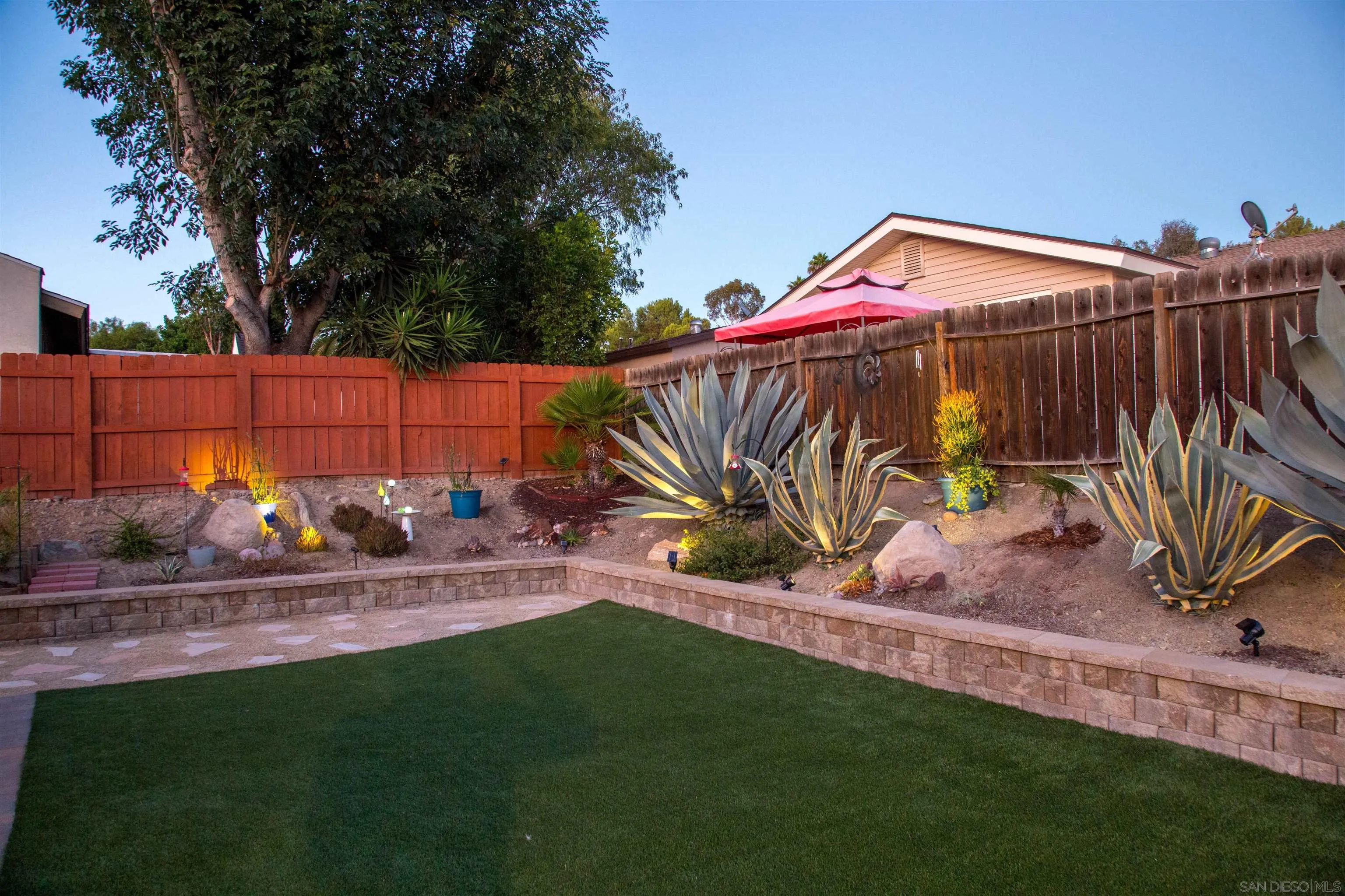 13515 Utopia Road Poway, CA 92064 - Photo 22 of 36 a view of a backyard with chairs potted plants and wooden fence