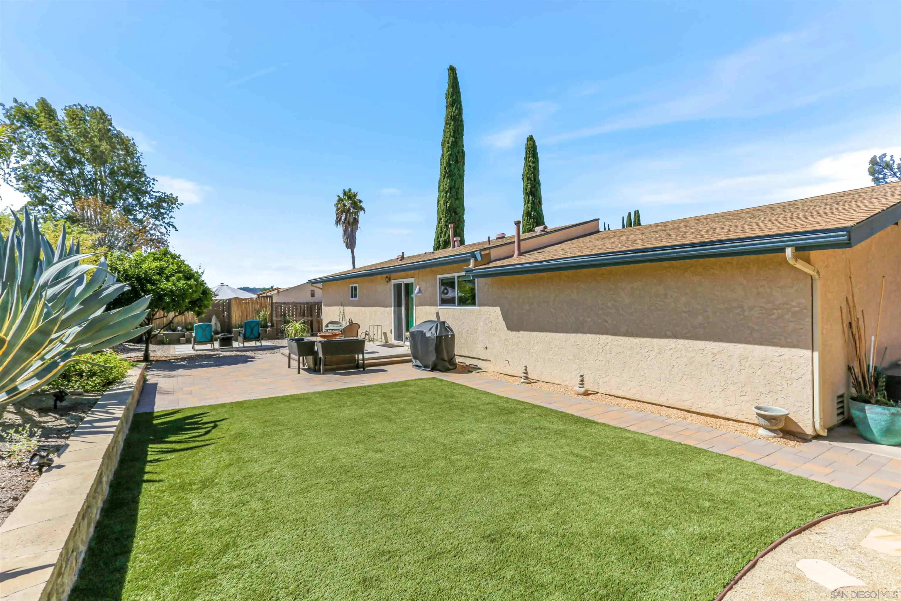 13515 Utopia Road Poway, CA 92064 - Photo 26 of 36 a view of a backyard with couches under an umbrella