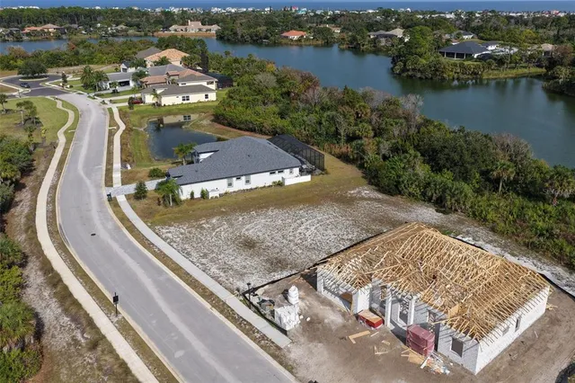an aerial view of a house with a lake view