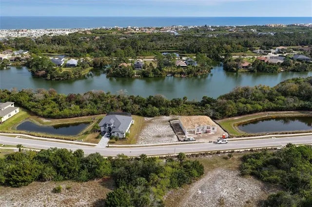 an aerial view of a house with a lake view
