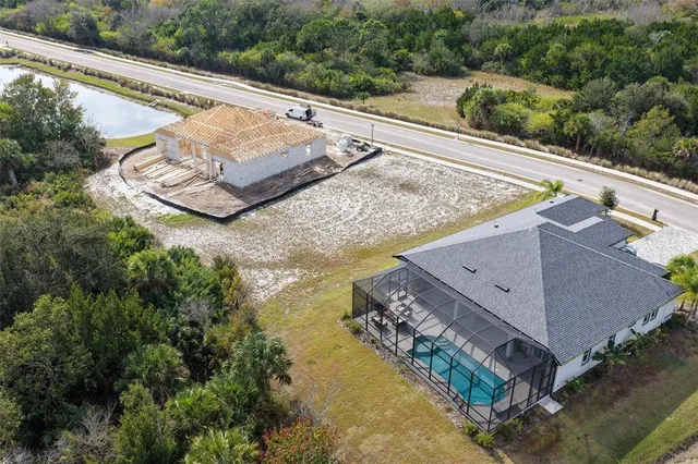 an aerial view of a house with a lake view