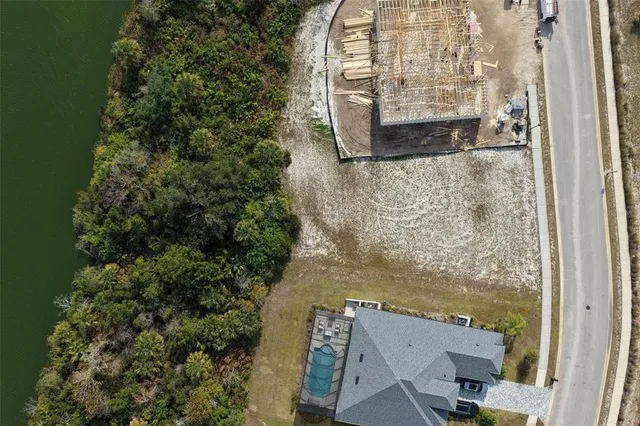 an aerial view of a house with a lake view