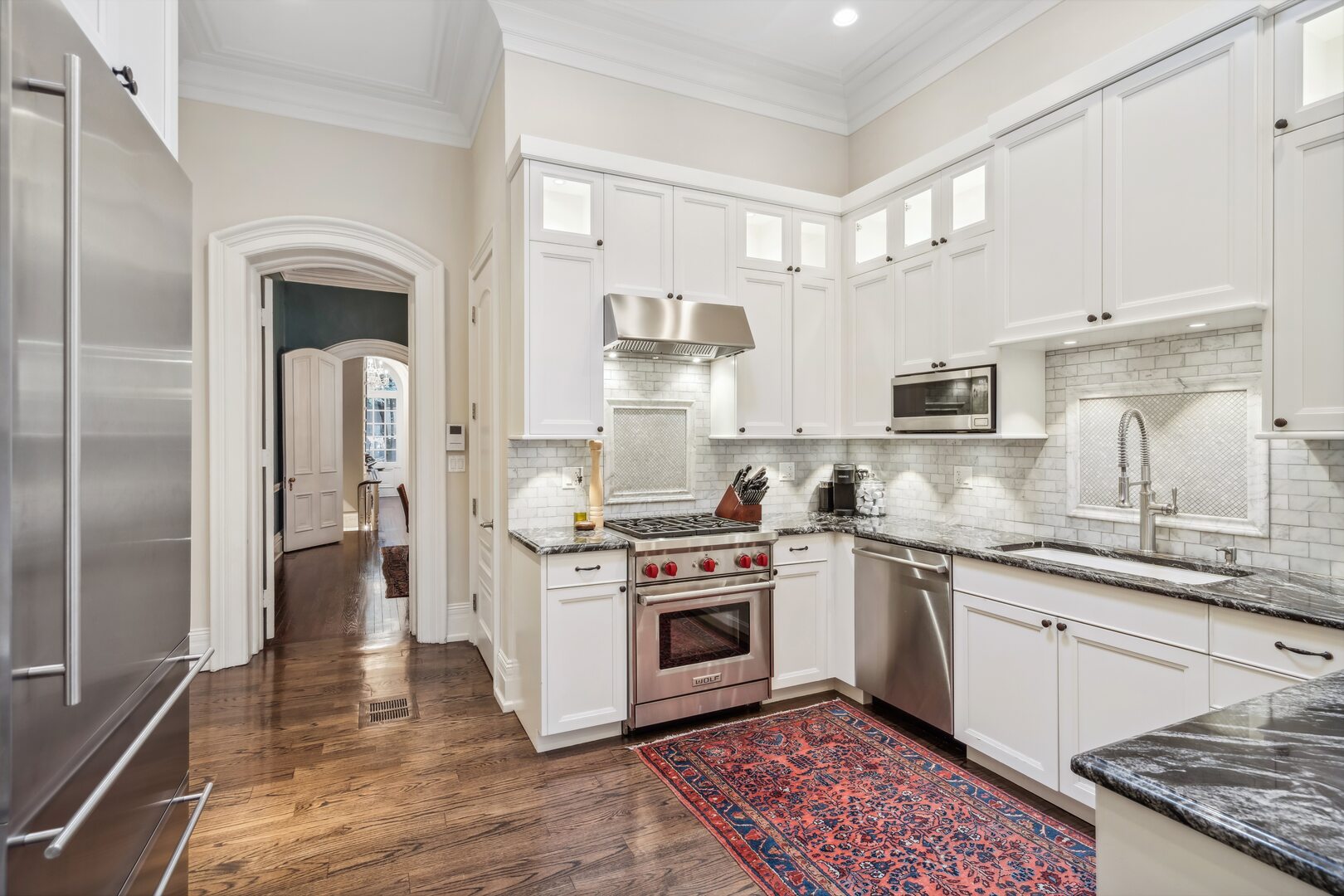 24 West Chestnut Street Chicago, IL 60610 - Photo 12 of 38 a kitchen with stainless steel appliances granite countertop a stove sink and cabinets