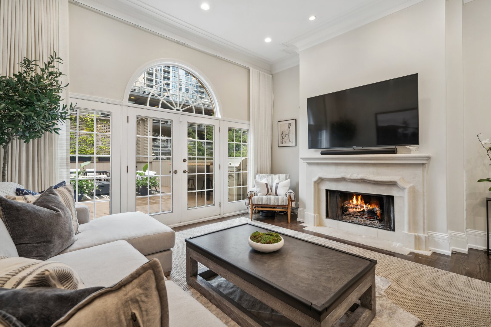 24 West Chestnut Street Chicago, IL 60610 - Photo 13 of 38 a living room with furniture a flat screen tv and a fireplace