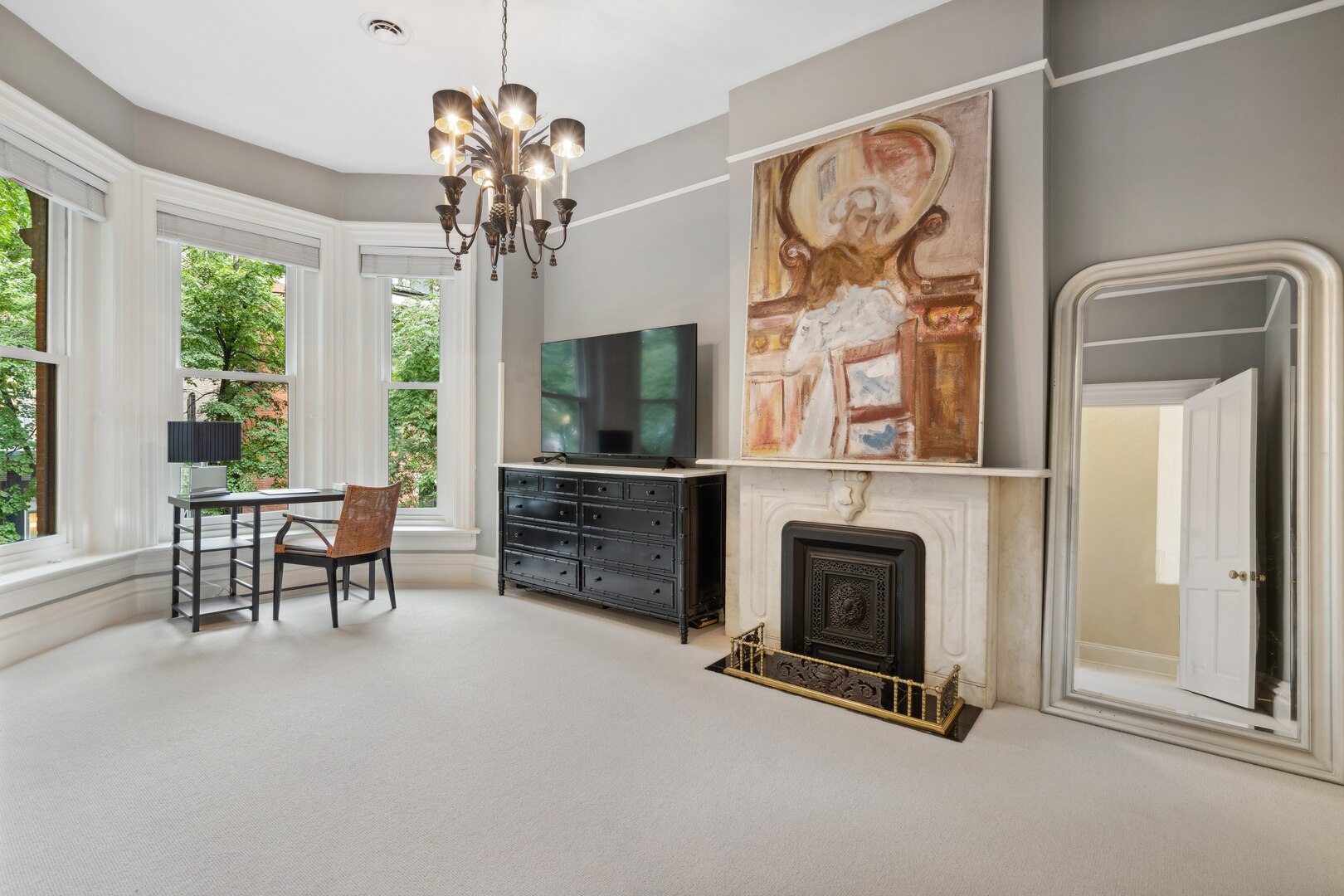 24 West Chestnut Street Chicago, IL 60610 - Photo 20 of 38 a livingroom with fireplace chandelier and windows