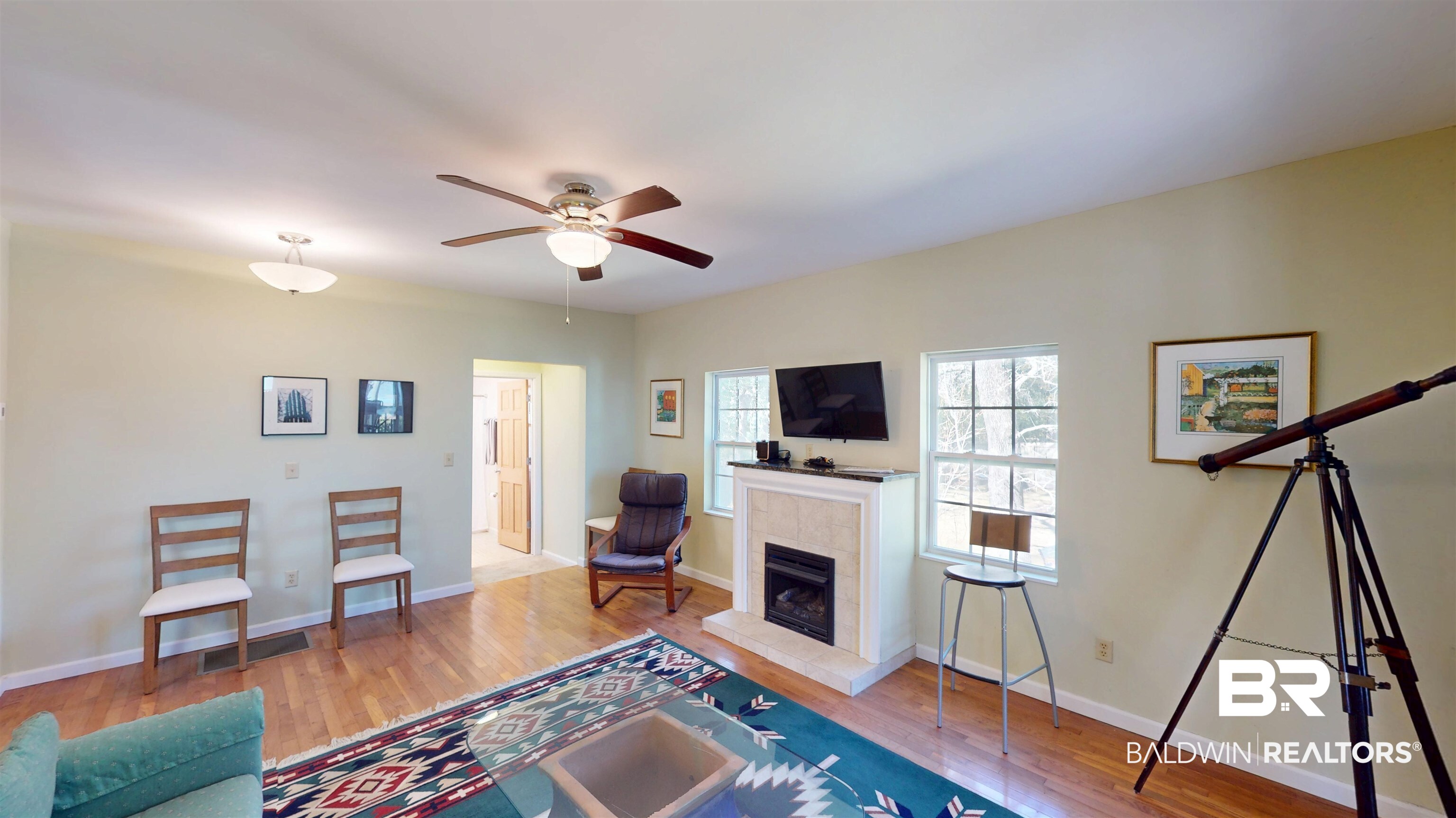 3220 Bayfront Road Mobile, AL 36605 - Photo 27 of 43 Living area featuring light wood-style flooring, a tile fireplace, and ceiling fan