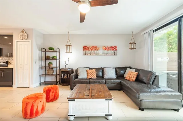 a living room with furniture and a open window