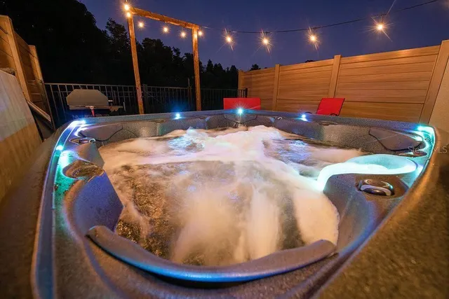 a bedroom with a bed and a flat tv screen on the dresser