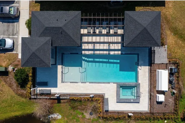 a view of a backyard with furniture and garden