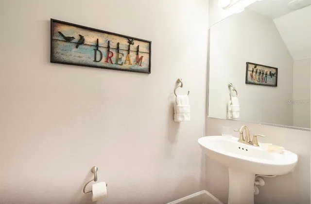 a bathroom with a sink and mirror