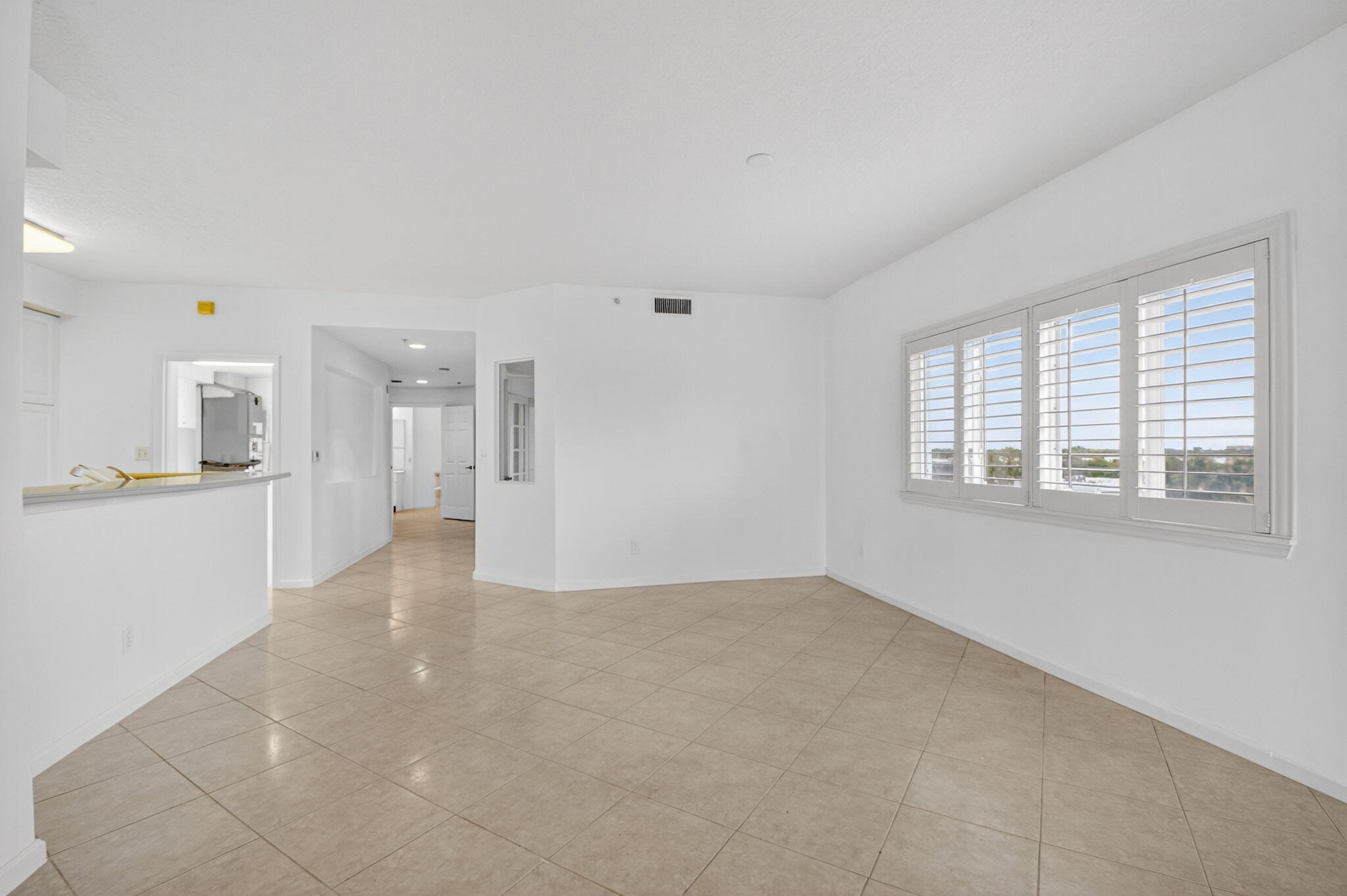 22715 Camino Del Mar, Unit 61 Boca Raton, FL 33433 - Photo 18 of 39 a view of a big room with windows and kitchen view