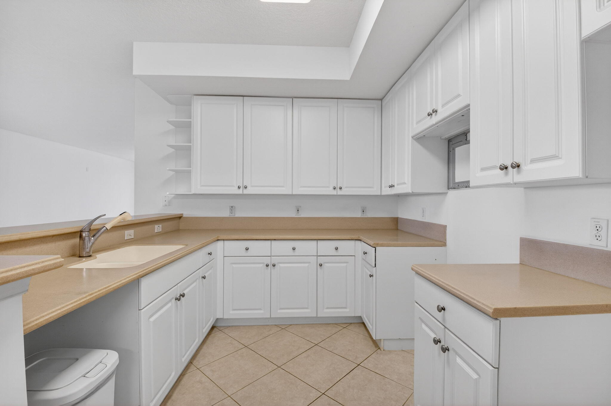 22715 Camino Del Mar, Unit 61 Boca Raton, FL 33433 - Photo 24 of 39 a kitchen with a sink and cabinets