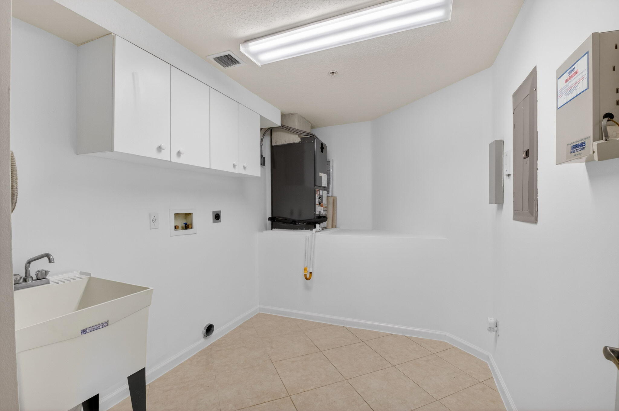 22715 Camino Del Mar, Unit 61 Boca Raton, FL 33433 - Photo 27 of 39 a view of a kitchen with white cabinets