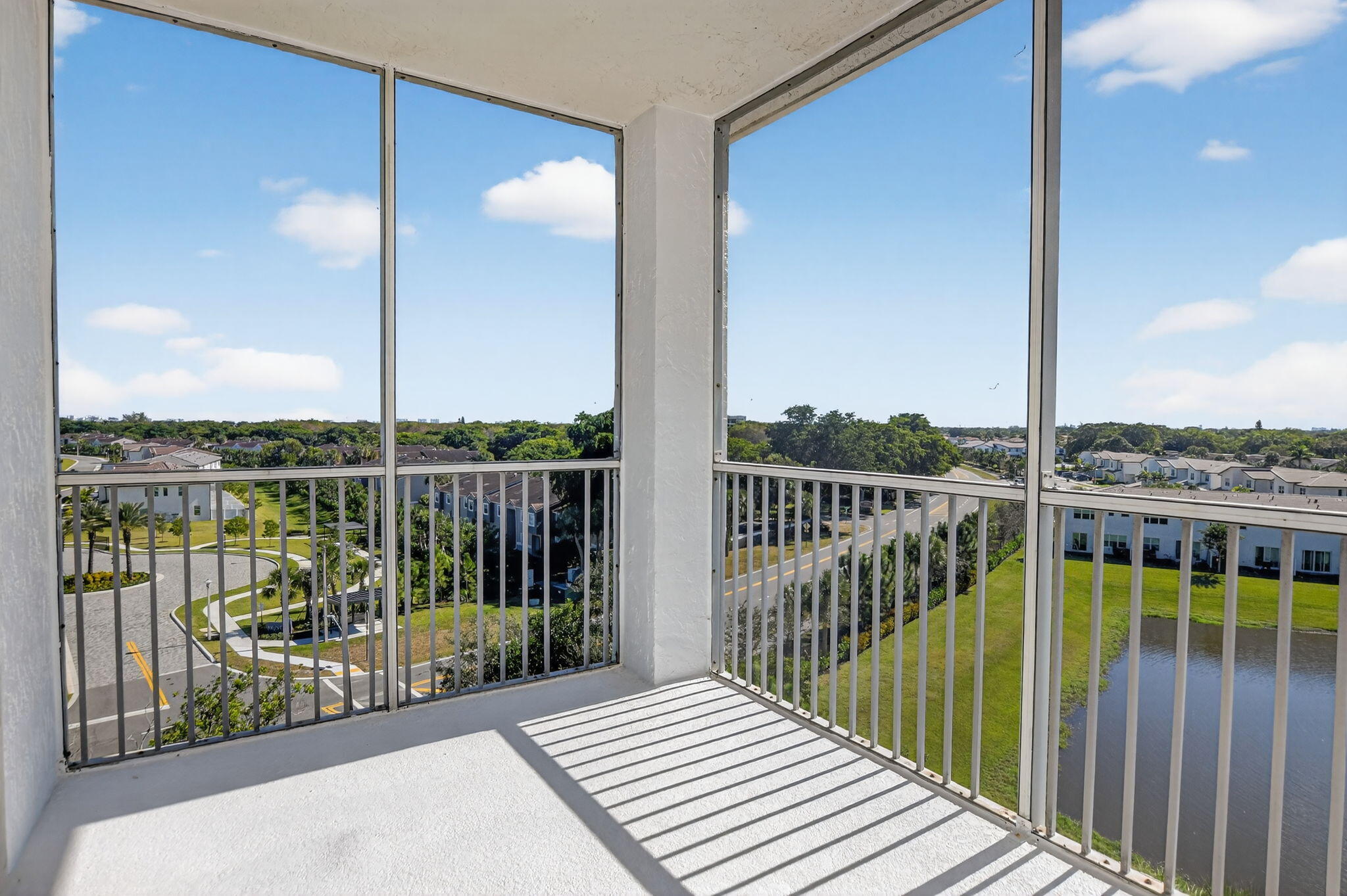 22715 Camino Del Mar, Unit 61 Boca Raton, FL 33433 - Photo 3 of 39 a view of a balcony with floor to ceiling window wooden floor and fence