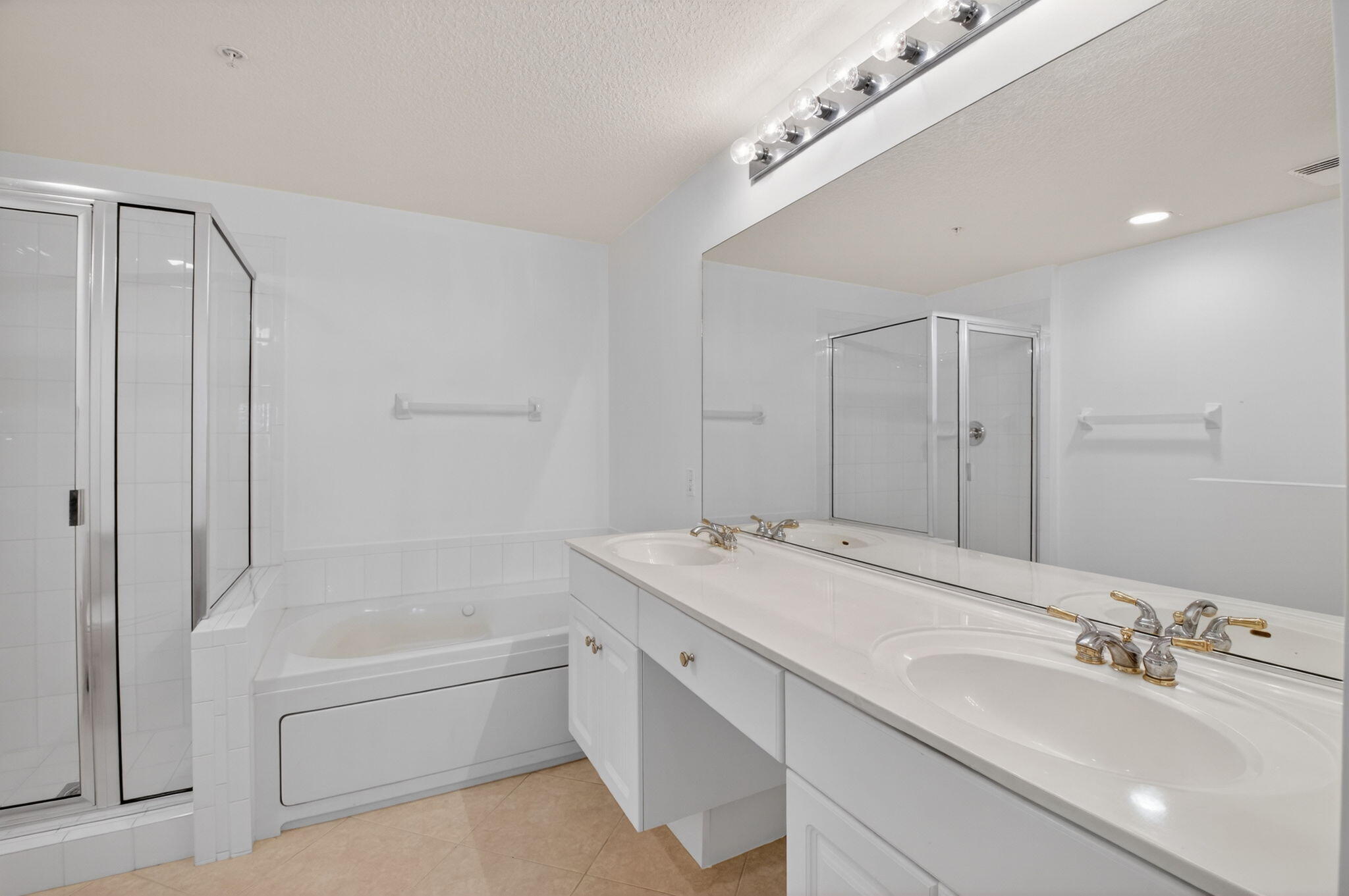 22715 Camino Del Mar, Unit 61 Boca Raton, FL 33433 - Photo 32 of 39 a bathroom with a tub a sink and mirror