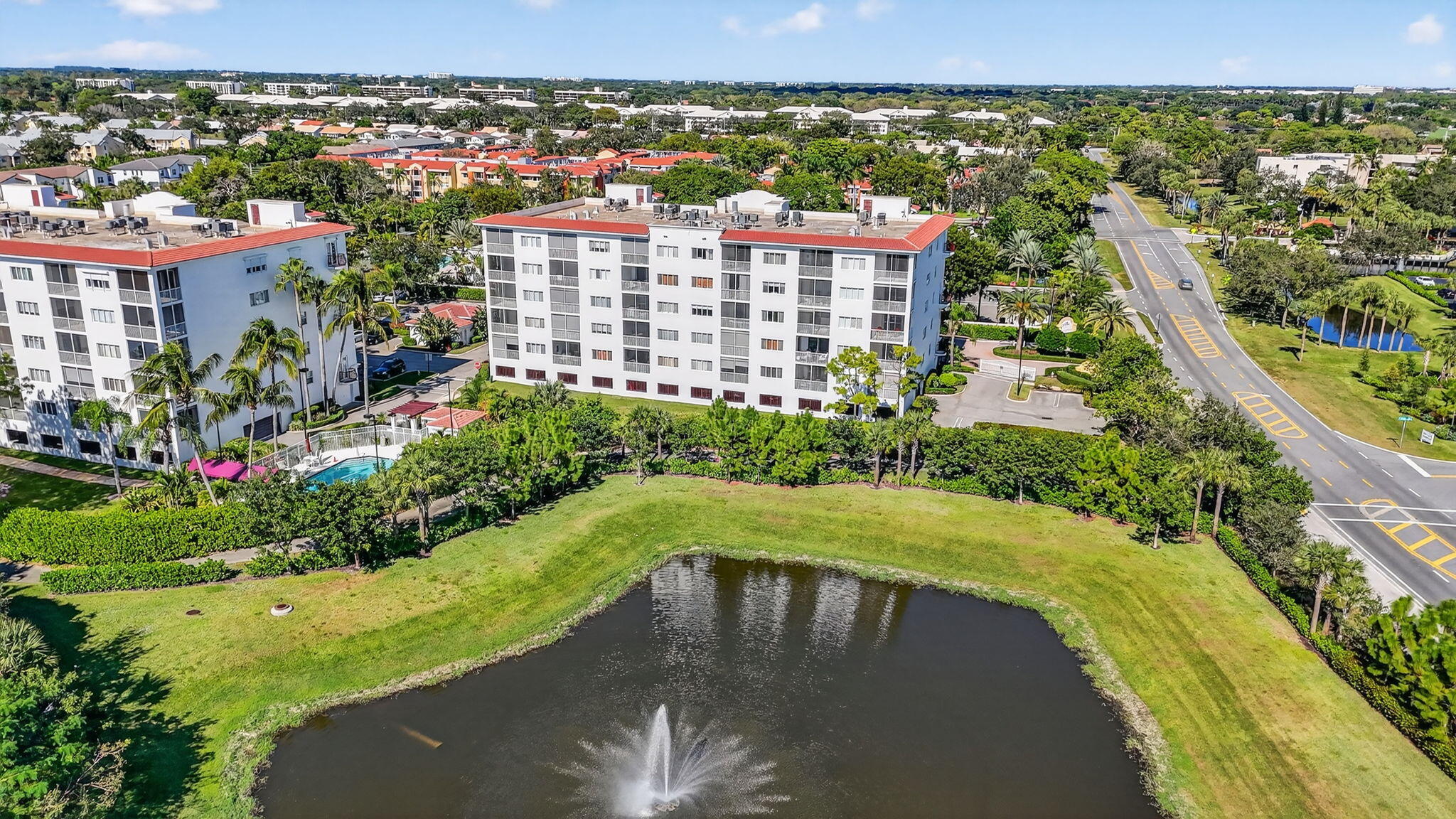 22715 Camino Del Mar, Unit 61 Boca Raton, FL 33433 - Photo 35 of 39 a view of a swimming pool with a garden