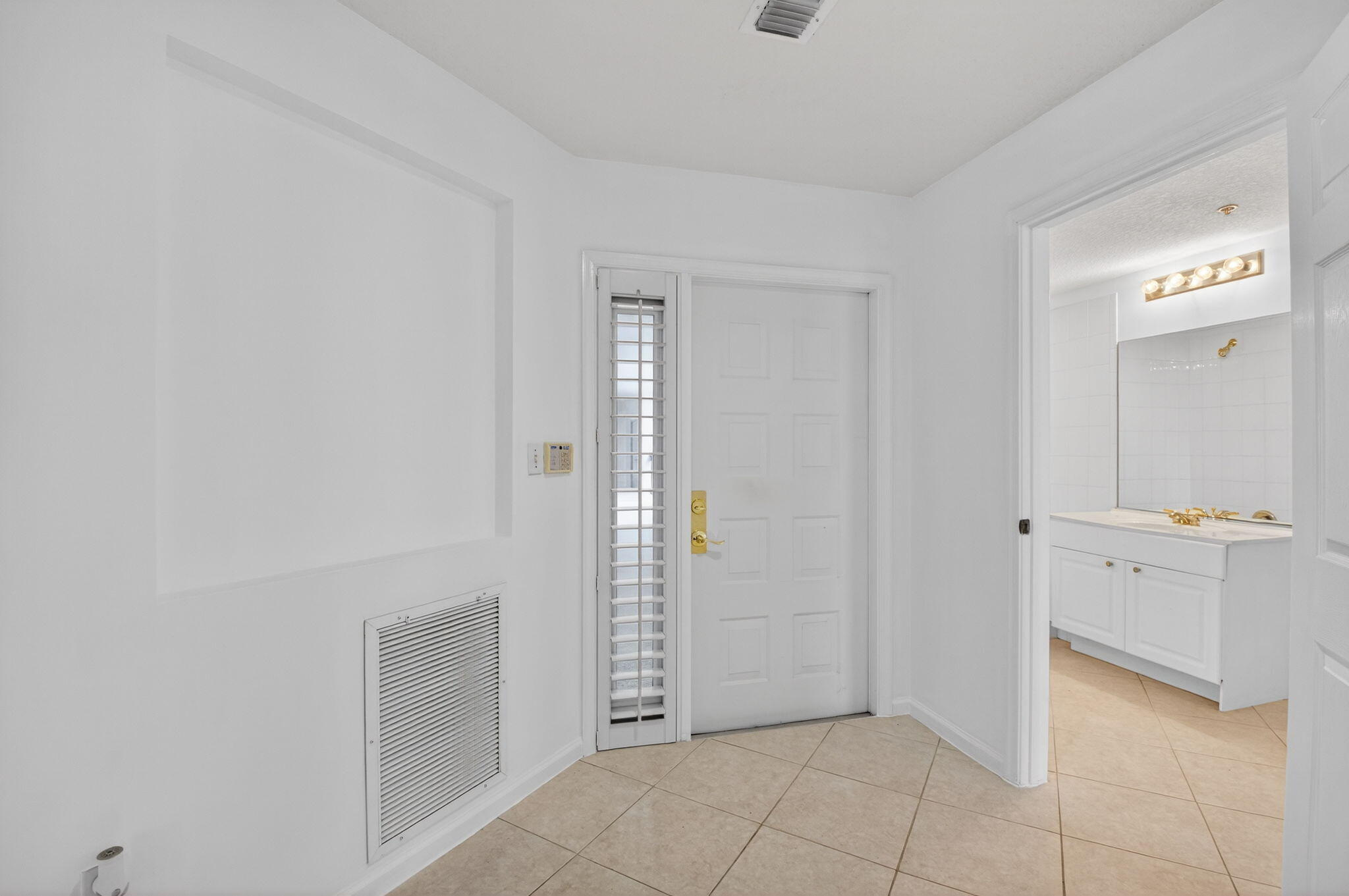 22715 Camino Del Mar, Unit 61 Boca Raton, FL 33433 - Photo 9 of 39 an empty room with mirror