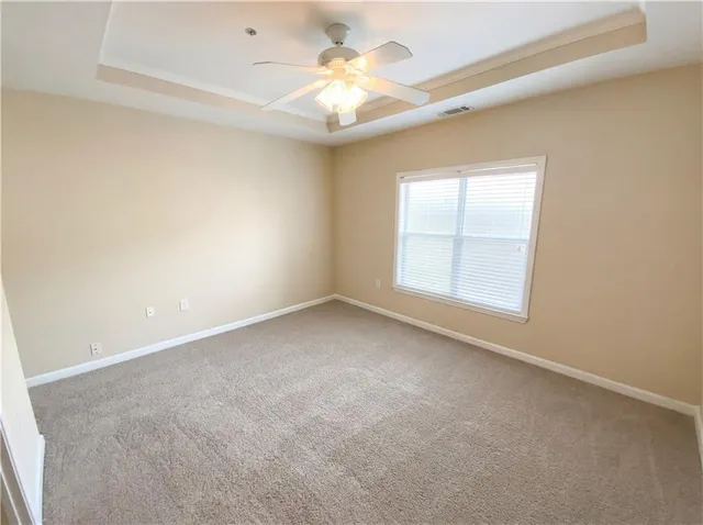 a spacious bathroom with a tub sink and mirror