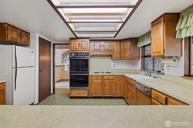 a kitchen with granite countertop stainless steel appliances and sink