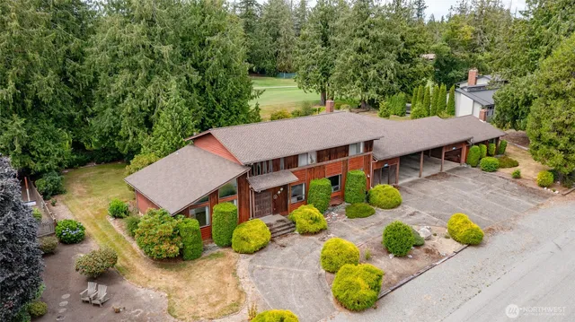 an aerial view of a house with swimming pool and garden