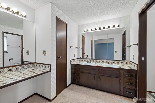 a bathroom with a toilet a sink and shower