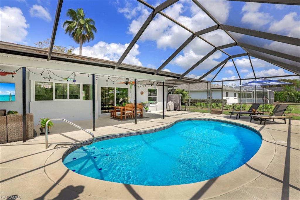 1010 Nottingham Drive Naples, FL 34109 - Photo 20 of 28 a view of a swimming pool with a patio