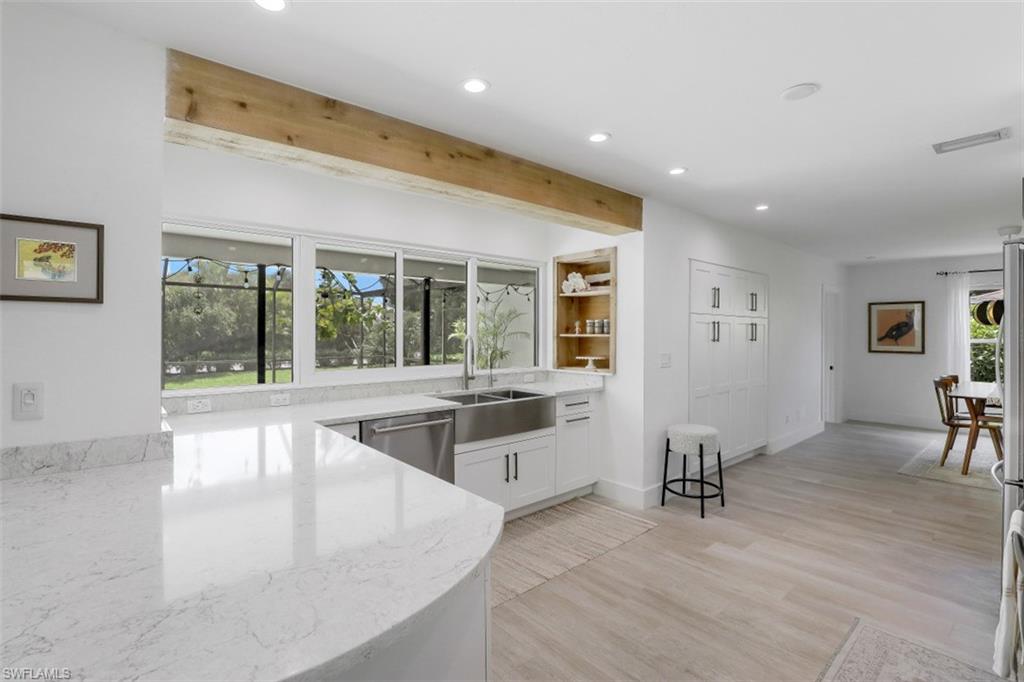 1010 Nottingham Drive Naples, FL 34109 - Photo 6 of 28 a view of a living room and kitchen view
