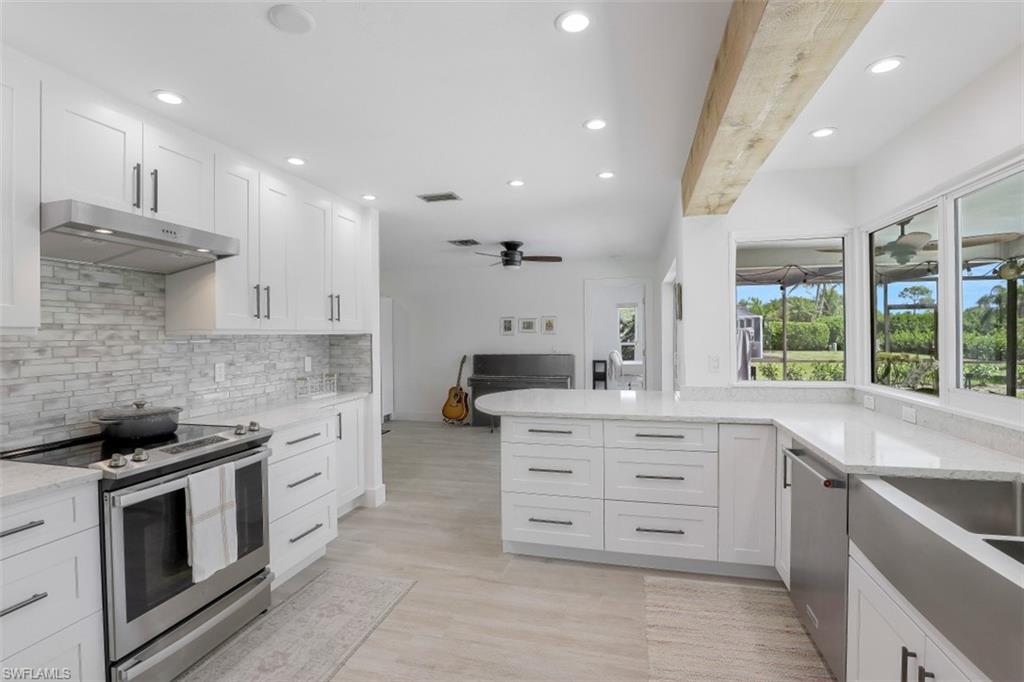 1010 Nottingham Drive Naples, FL 34109 - Photo 8 of 28 a large kitchen with stainless steel appliances granite countertop a stove and a sink