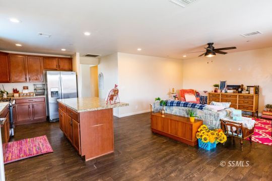 913 South McCall Street Ridgecrest, CA 93555 - Photo 11 of 40 a kitchen with stainless steel appliances granite countertop a stove and a refrigerator