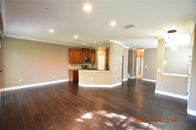 a view of a room with wooden floor and a window