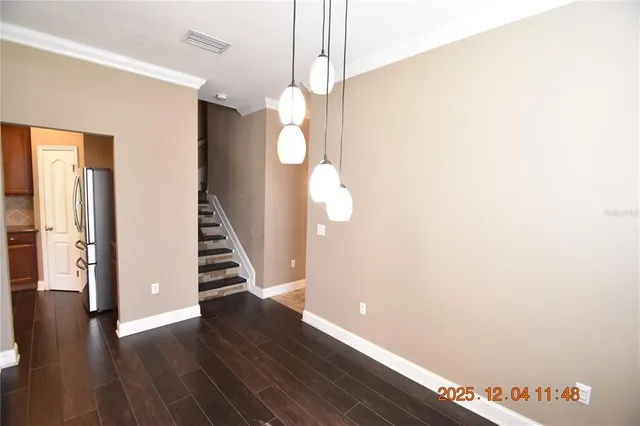 a kitchen with stainless steel appliances granite countertop a sink and a refrigerator