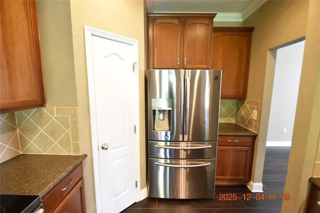 a kitchen with granite countertop cabinets stainless steel appliances and a window