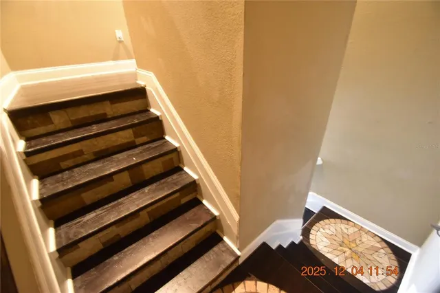 a view of a room with wooden floor and windows