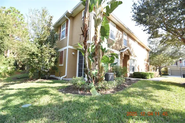 a view of a house with a yard and pathway