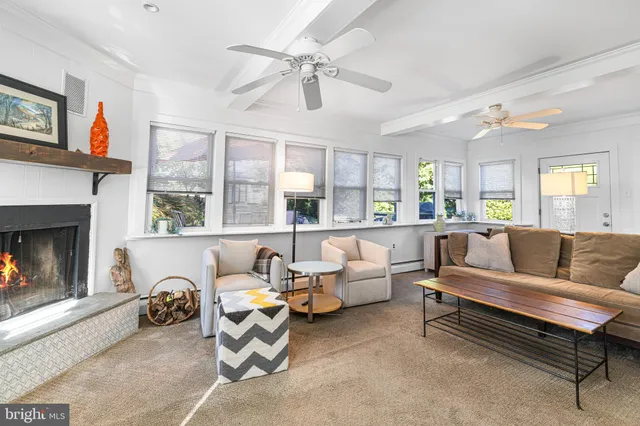 a living room with furniture and a fireplace
