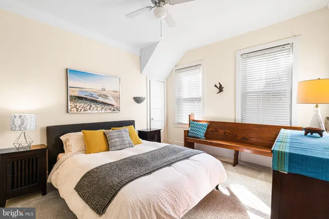 a bedroom with a bed a couch and a window