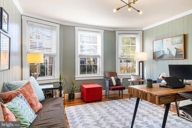 a living room with furniture fireplace and a table
