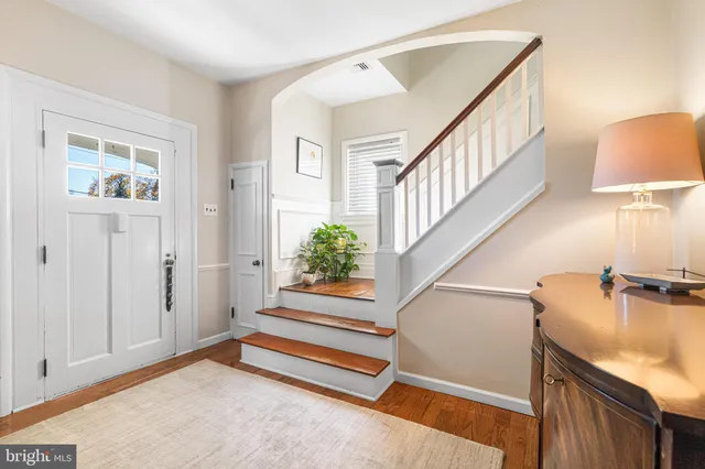 a view of entryway and hall with wooden floor