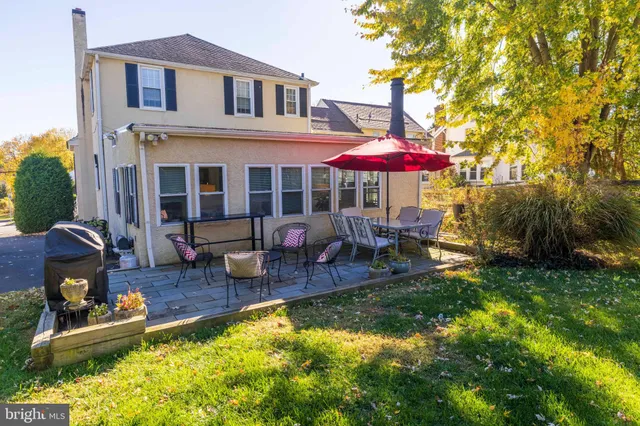 a front view of house with yard and outdoor seating