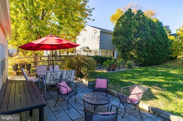 a view of a patio with furniture and a yard