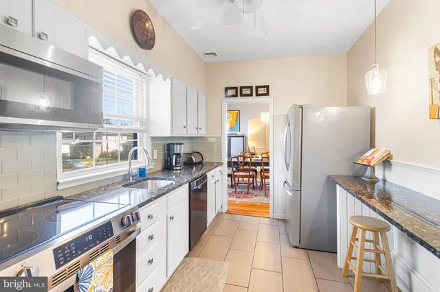a kitchen with refrigerator and window