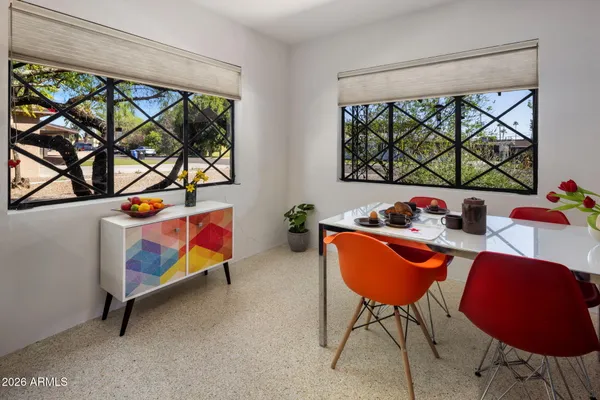 a spacious bedroom with a bed and a large window