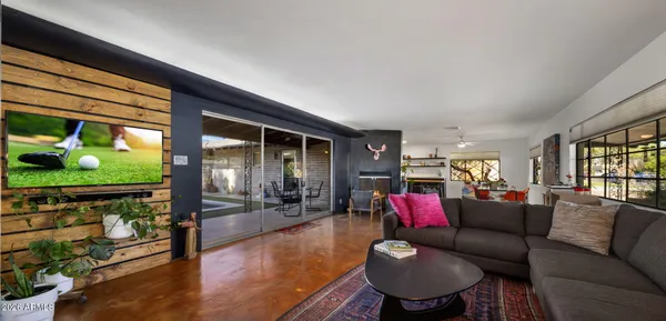 a living room with furniture and a floor to ceiling window